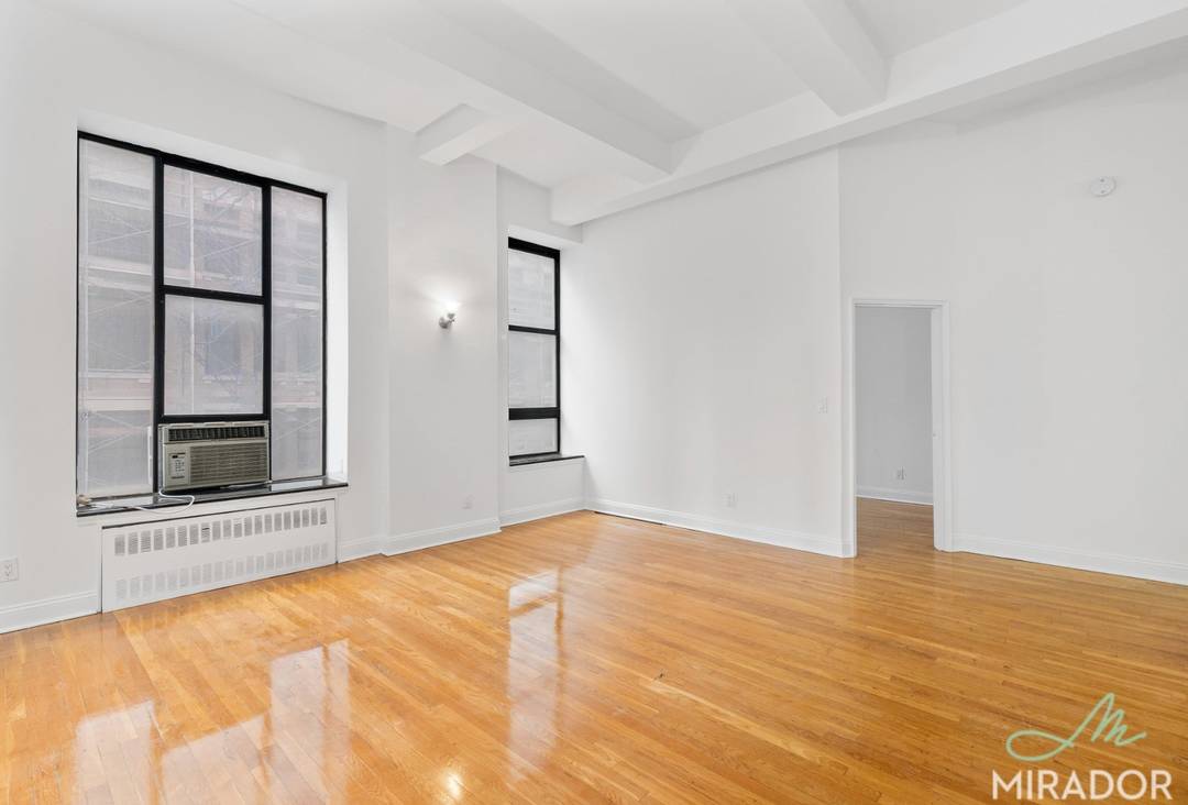 This gorgeous corner unit has a lofty massive space with super high ceilings throughout.