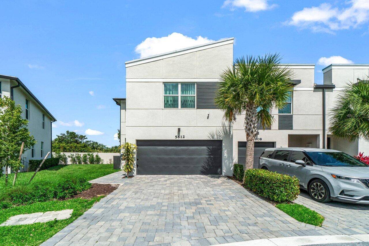 Discover this newly built 2022 end unit townhome in the gated Enclave at Mangonia community.