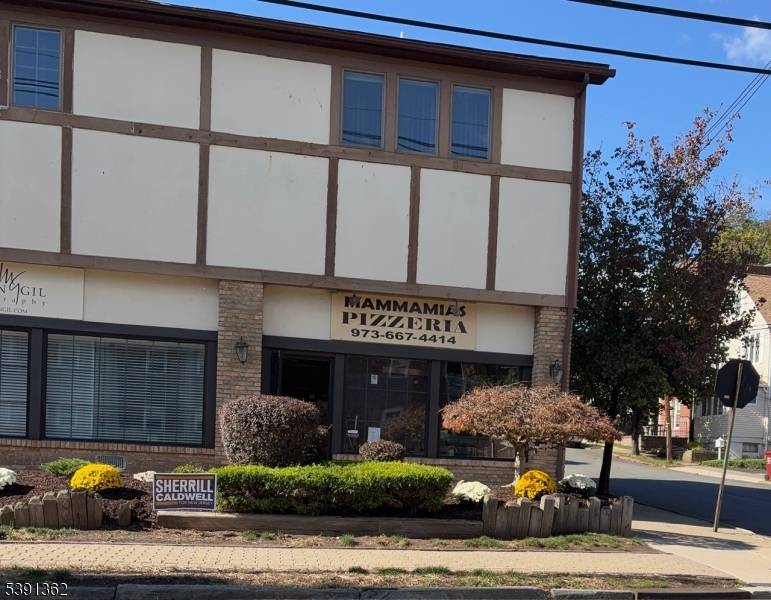 Pizzeria located on a corner in a small strip mall in a mixed use building on a busy street in Nutley.