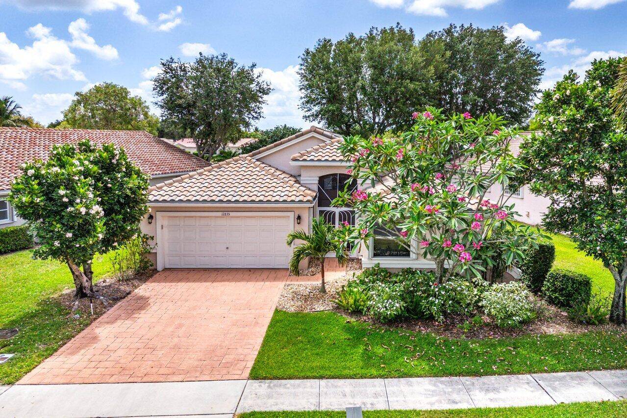 Lakefront single family home nestled amongst vibrant flowering trees and expansive long lake views.