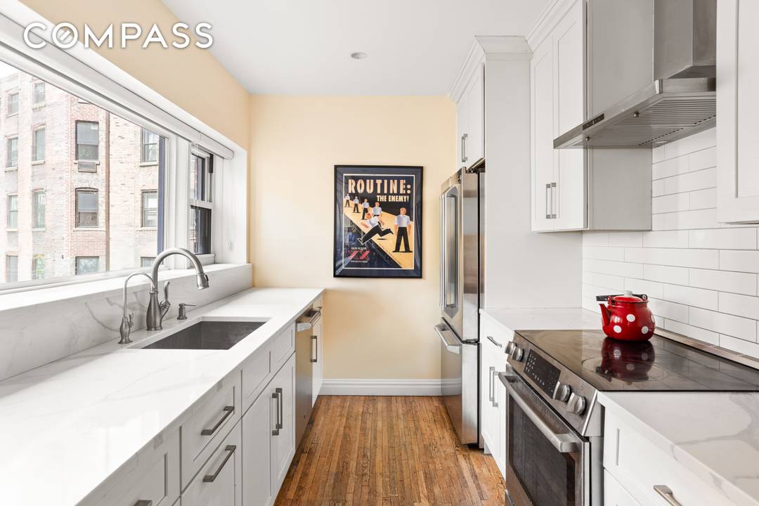 Enter this lovely home and immediately be greeted by beautiful prewar details, including an expansive custom wooden built in bookcase, moldings, oak hardwood flooring, and more.