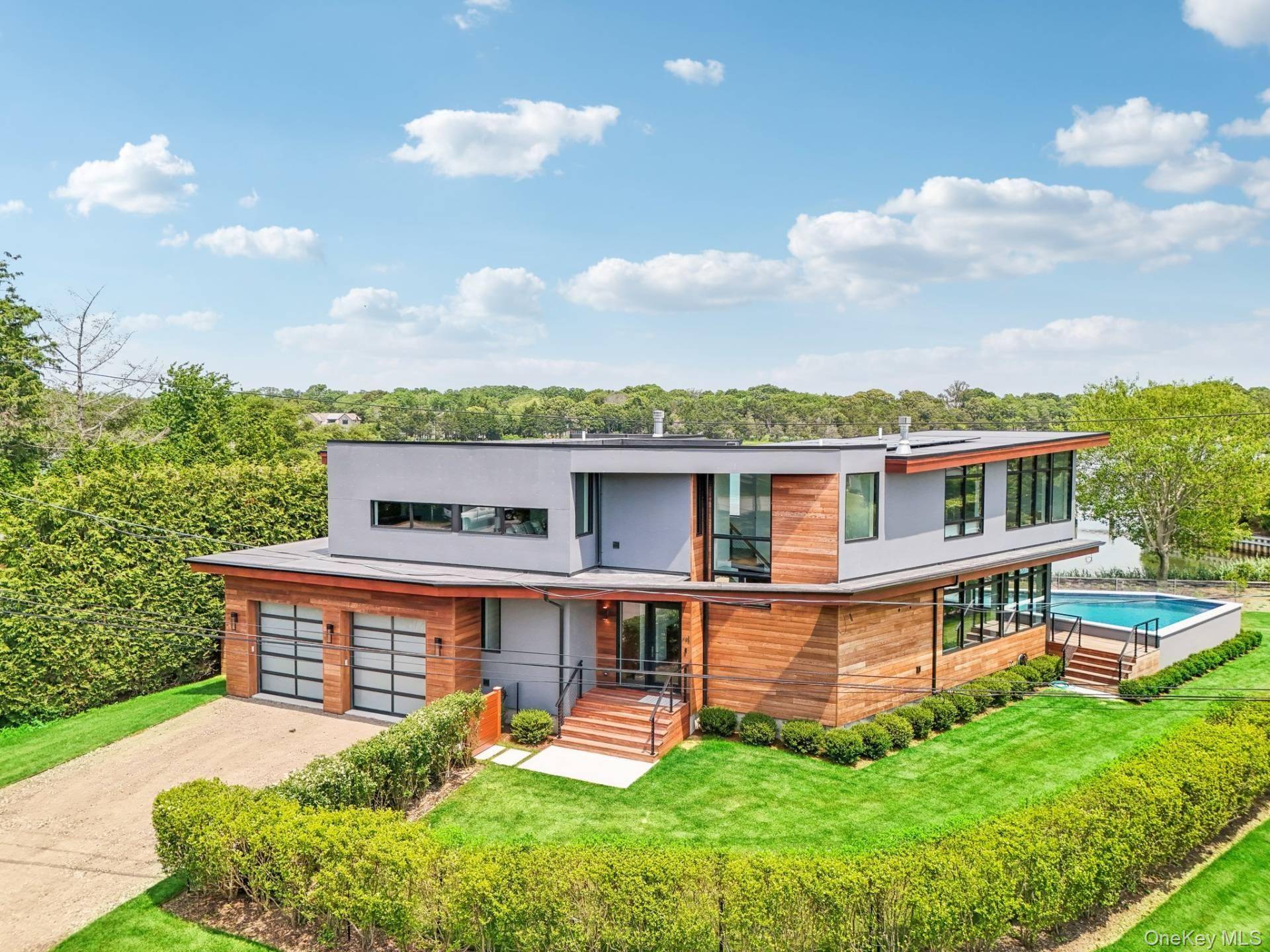 Sag Harbor Modern Waterfront This exquisite five bedroom, five and a half bath residence, a creation by the esteemed Turkel Design, is meticulously crafted to leverage its prime location, offering ...