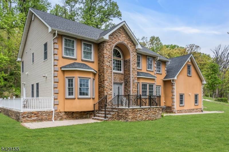 Stunning 4BR, 4. 5BA home featuring a grand 2 story foyer, hardwood floors, and a gourmet kitchen with center island, 5 burner stove, wall oven, pantry, and stone counters.