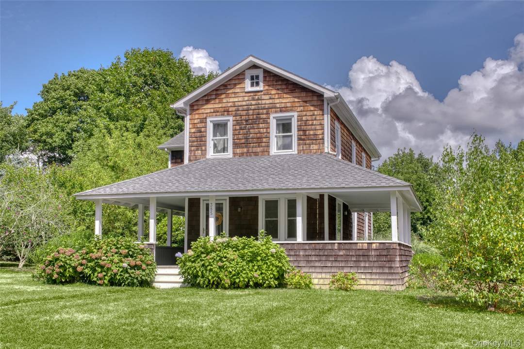 Stately and classic vintage farmhouse with wrap around porch, original in tact architectural details and hardwood floors throughout.