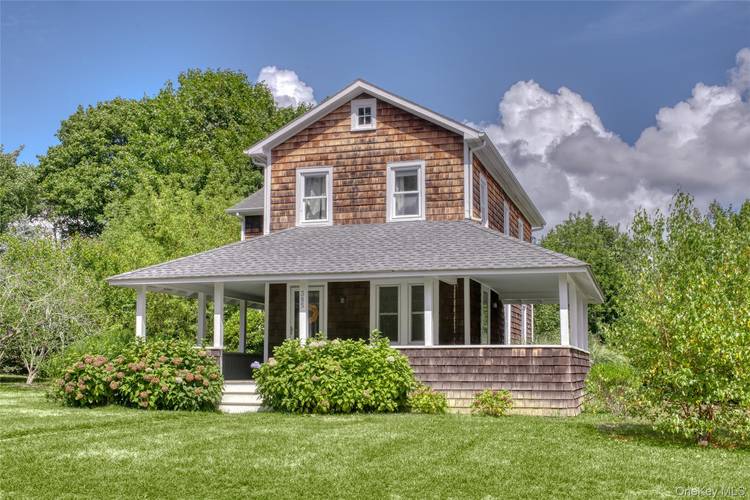 Stately and classic vintage farmhouse with wrap around porch, original in tact architectural details and hardwood floors throughout.