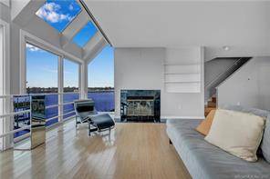 Exquisite, contemporary condo with window walls throughout, offering extraordinary 180 degrees panoramic water views of the New Haven Harbor Long Island Sound.