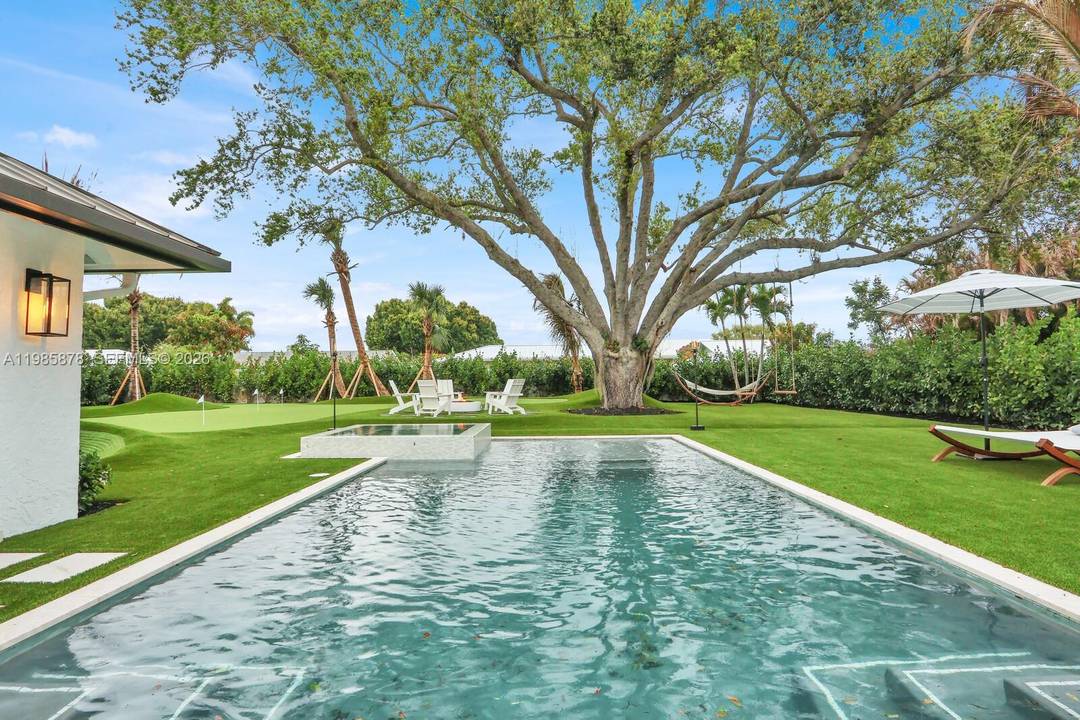 Interior designer completely rebuilt and re imagined luxury modern coastal residence on a rare half acre lot beneath mature live oaks.