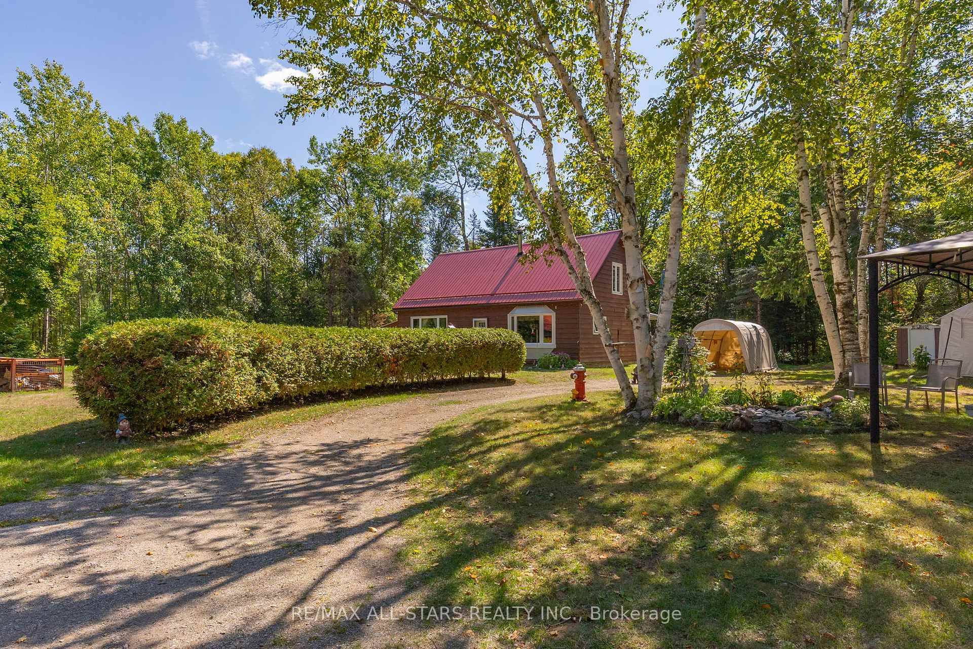 Step into this inviting 3 bedroom, 1 bathroom, open concept home, where vaulted ceilings and sun filled windows frame a cozy wood stove at the heart of the living space.