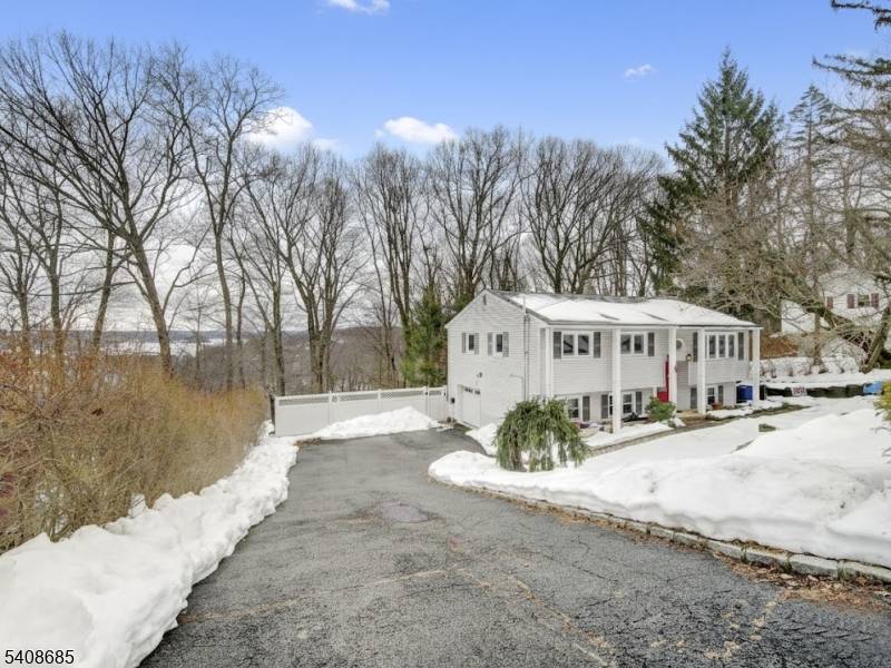 LAKE VIEWS, IN GROUND POOL, Enjoy peaceful views of Lake Hopatcong from the backyard of this spacious and inviting bi level home, offering a wonderful blend of comfort, space, and ...