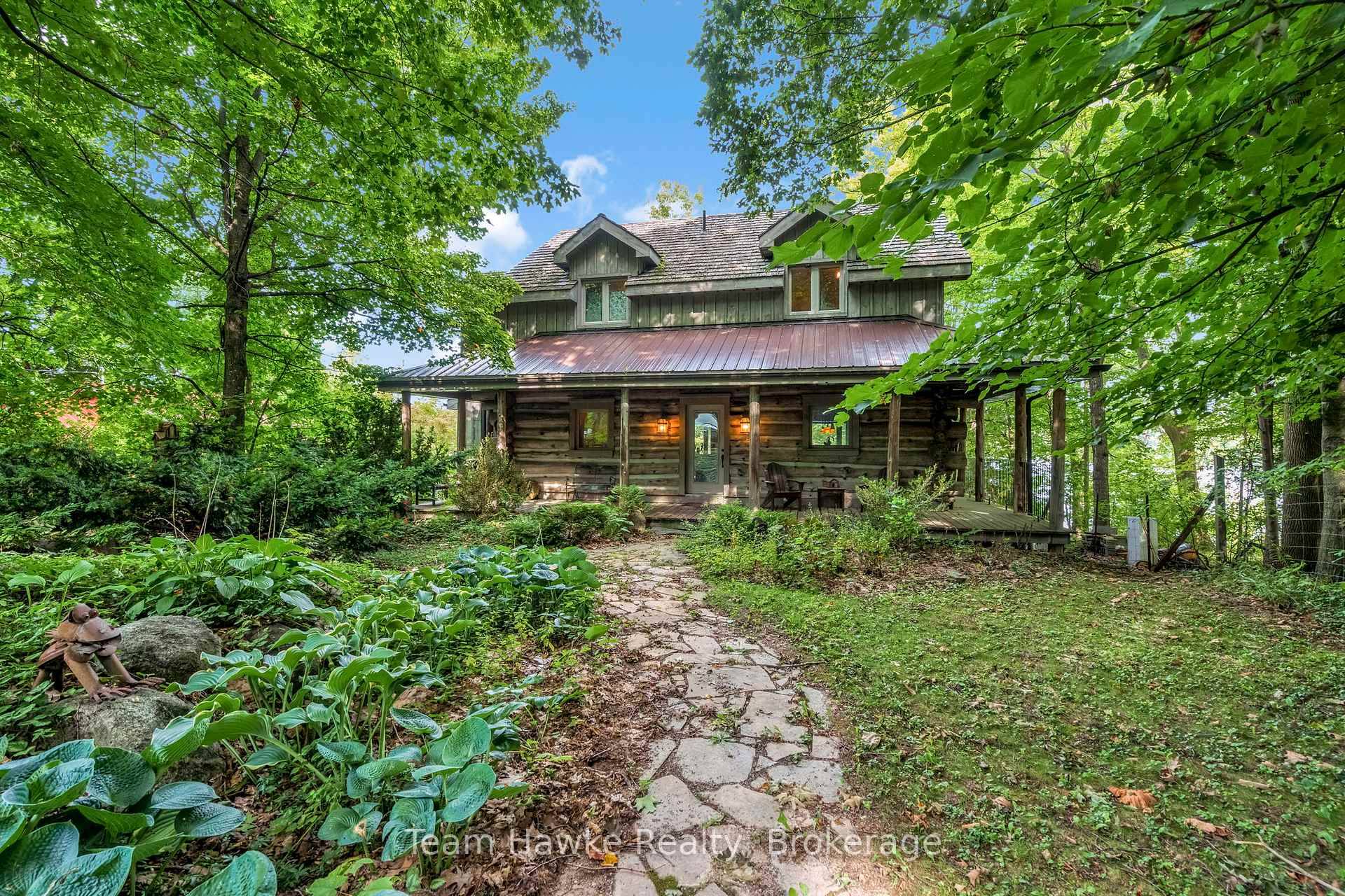 One of only eleven waterfront properties on Sumac Lane, this stunning four season log home, built in 2005, offers just under 74 feet of frontage on Little Lake.