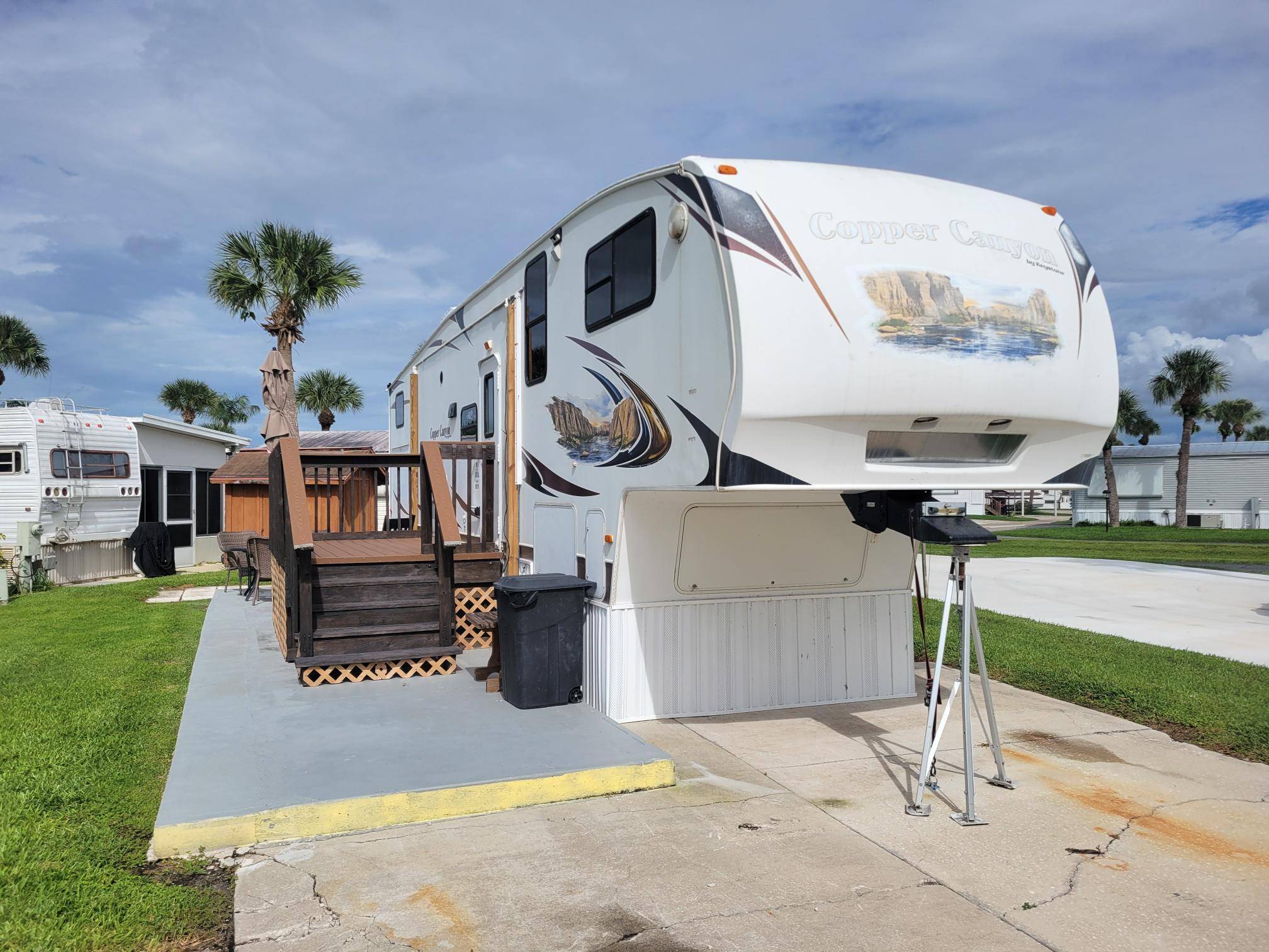 Presenting a well maintained fifth wheel residence within the desirable, 55 Ancient Oaks RV Resort.
