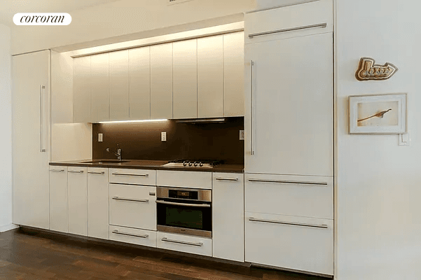 Bright and airy, this one bedroom home at The Gramercy by Starck offers a spacious layout with floor to ceiling windows and dark oak wood floors.