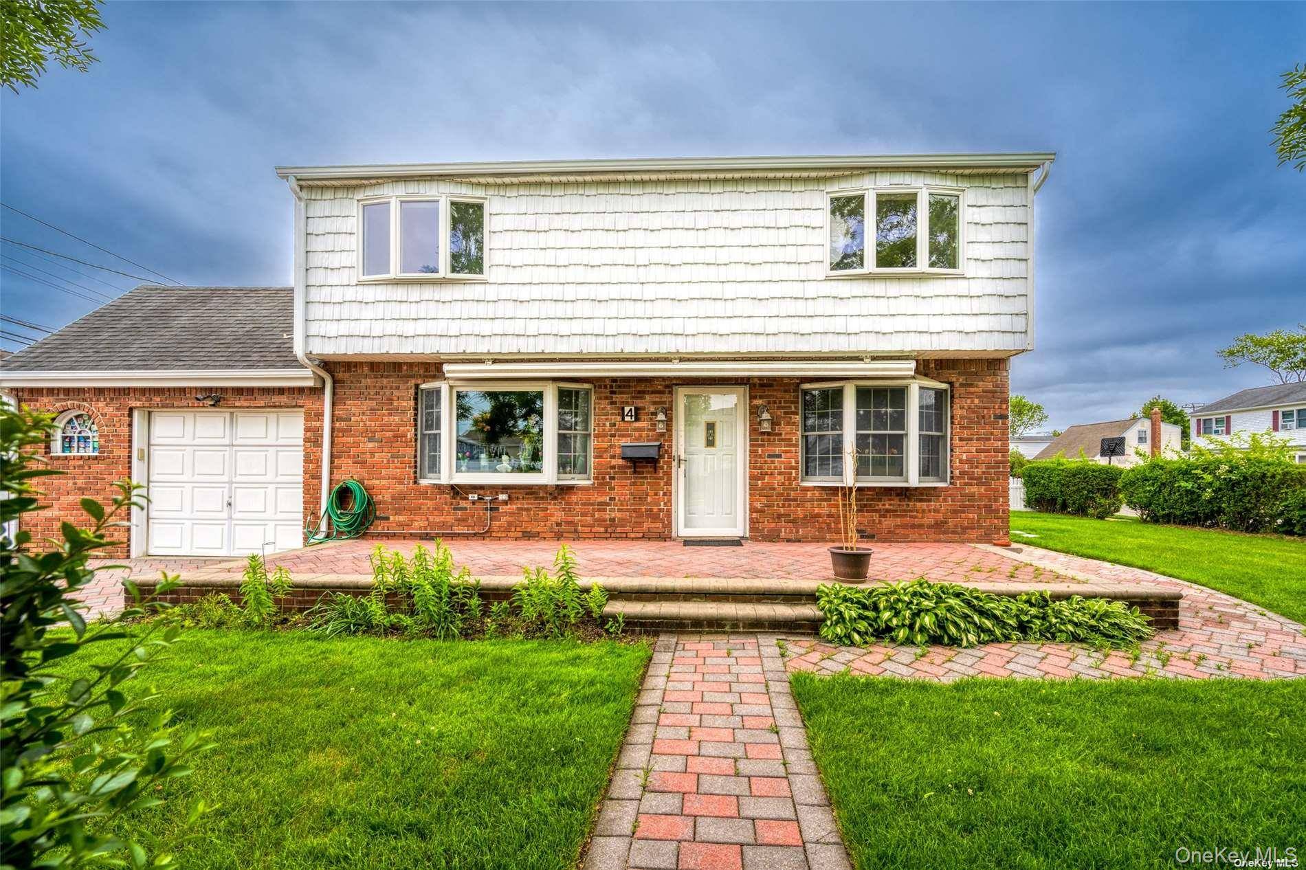 Experience timeless elegance in this distinguished Colonial home, graced with a striking red brick facade and charming front porch.