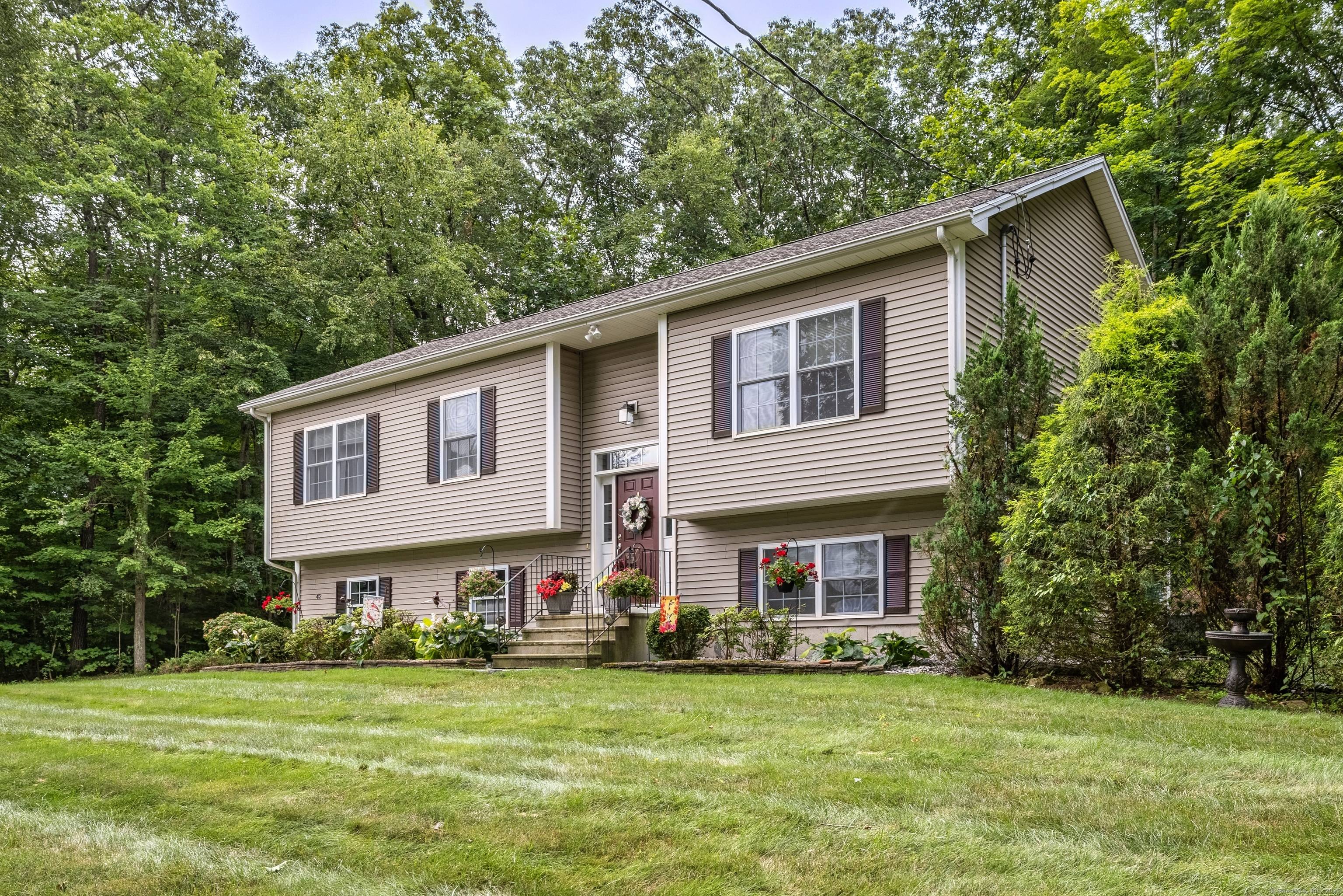 Quiet Living in a Charming Small Town Setting Tucked away on a pristine 1 2 acre lot, this custom designed raised ranch offers peaceful living with convenient access to local ...