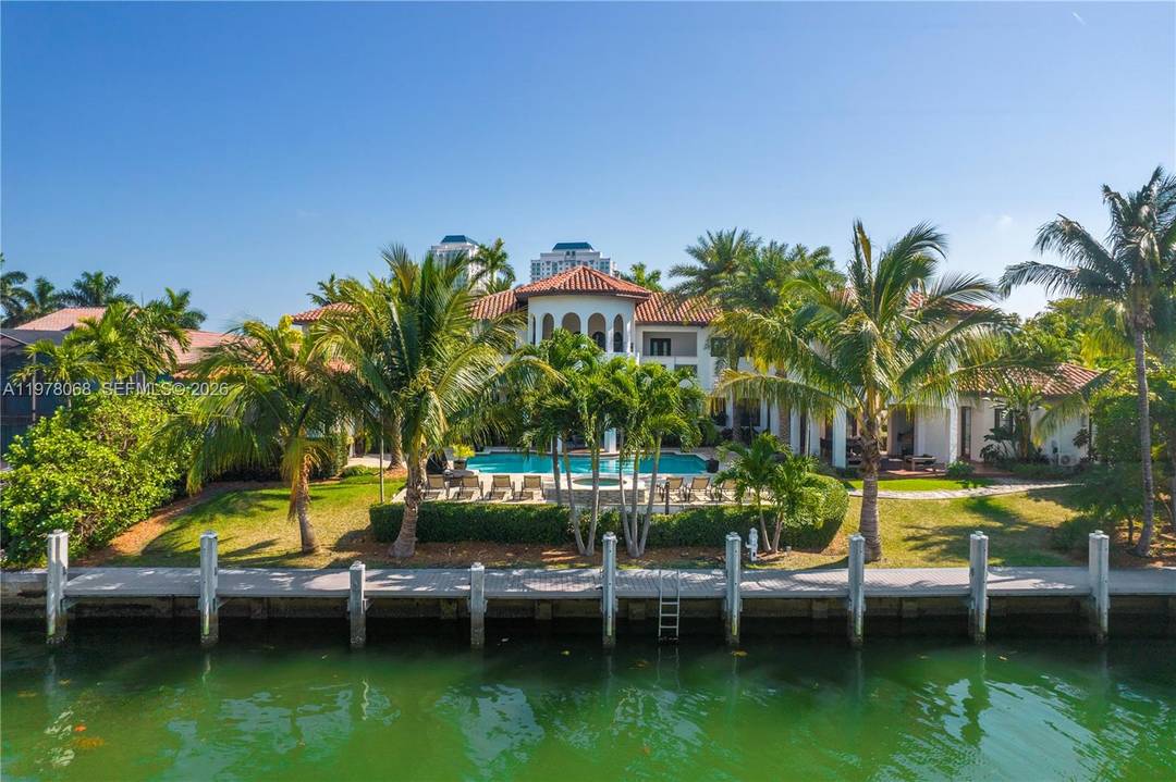 Experience luxury waterfront living in this Mediterranean style estate offering 140 feet of waterfrontage with direct open bay access.
