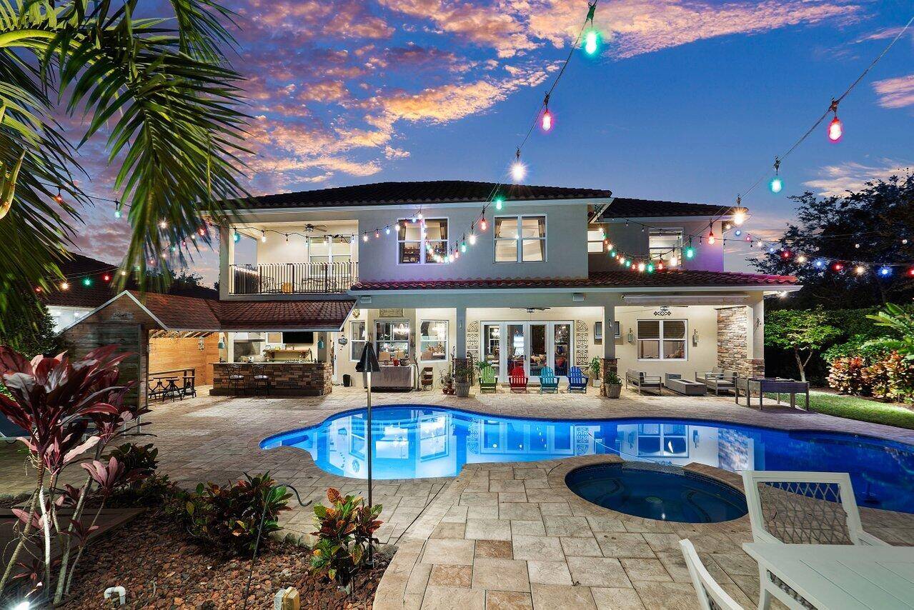 Absolutely Amazing, 7 Bedrooms Plus Office Estate home nestled on a corner lot in one of the most popular areas of South Florida !
