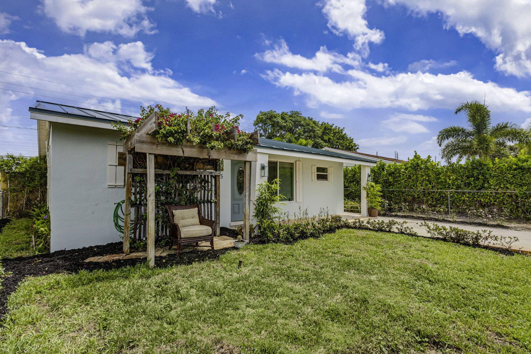 Dive into coastal bliss in this South East Florida sanctuary with its lush gardens, chic bar, open concept living.