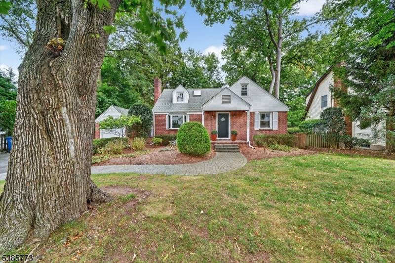 A quintessential brick Cape Cod complete with breezeway between house and garage in a lovely residential neighborhood setting.