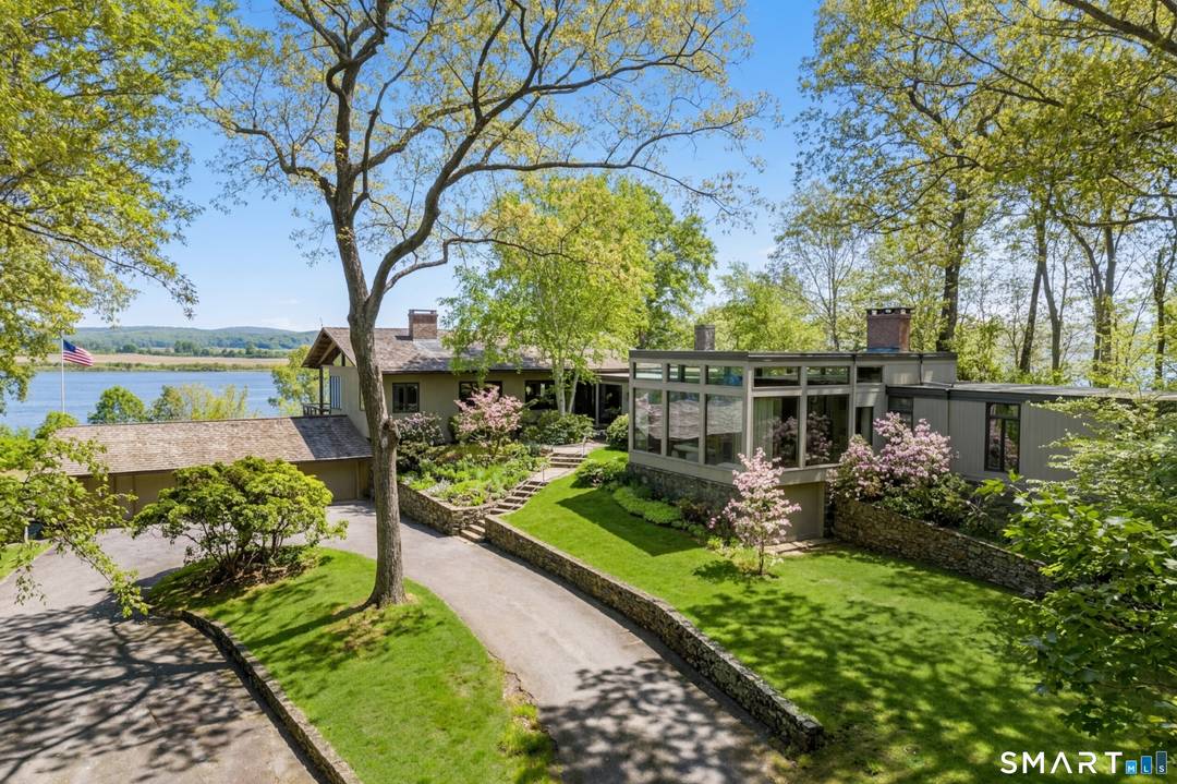 Discover one of the most coveted vantage points on the lower Connecticut River a mid century modern sanctuary perched on a private 2.