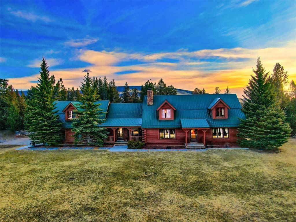 Custom Log Home with manicured property.