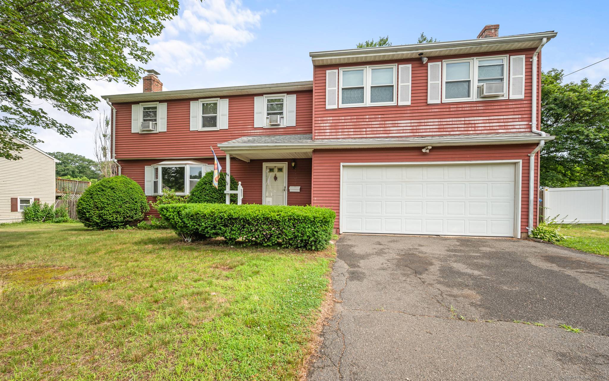 Spacious 4 Bedroom Colonial with complete In Law, Au Pair or Family Living with separate exterior entrance and private door into the Home.