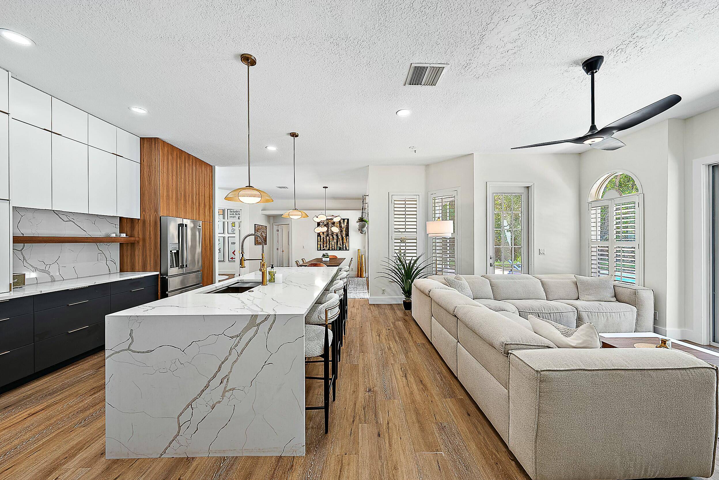 Nestled on 1. 55 acres of pristine land, this stunningly renovated Jupiter Farms estate offers modern elegance, privacy, and top tier upgrades throughout.