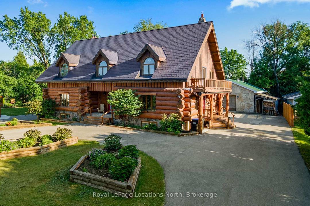 24 Oliver Crescent, a charming log home nestled on a spacious 120 x 225 lot backing onto the tranquil Pretty River.