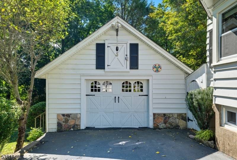 This charming vintage Colonial sits on a beautifully landscaped, park like property and blends classic style with modern updates.