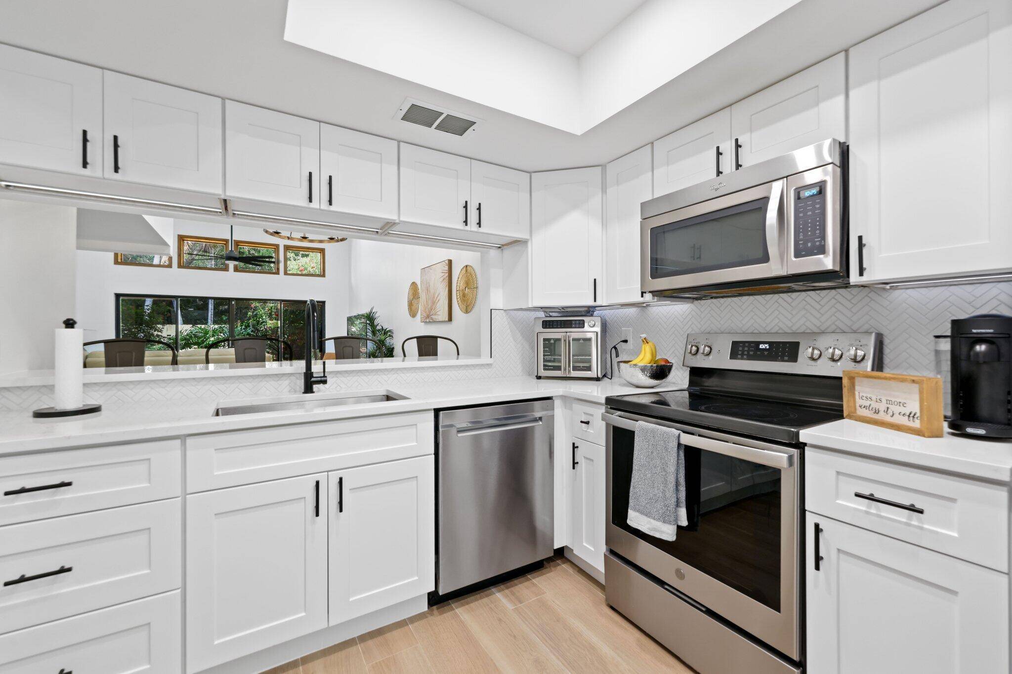 Stunning 3BR 2BA remodeled townhouse in East Boca's Woodlet community steps from FAU, Boca Regional Hospital, and Mizner Park.