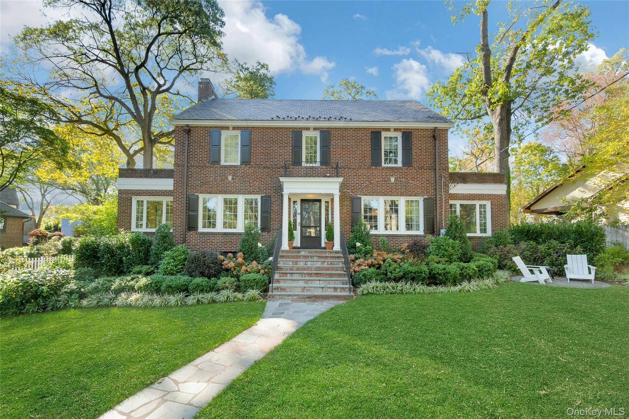 This classic brick center hall Colonial seamlessly blends timeless architecture with modern comfort and style.