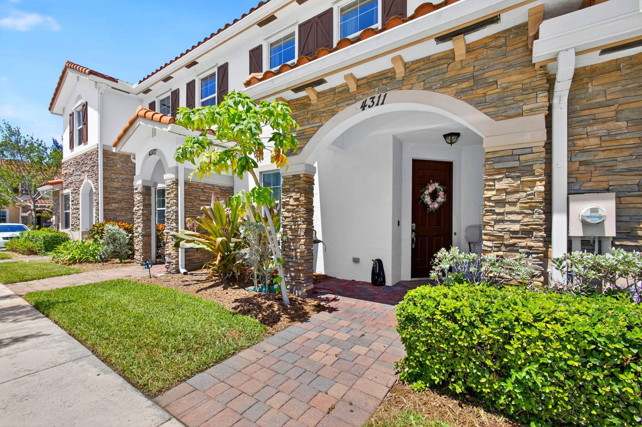 Welcome to 4311 Maybelle Lane a beautifully maintained townhouse nestled in a desirable gated community in the heart of West Palm Beach.
