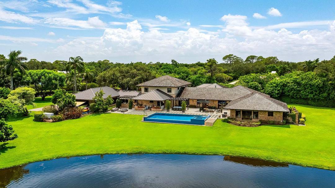 An extraordinary opportunity in the private, gated Village of Golf, 3 Peacock Lane offers over two acres of impeccably landscaped grounds with a serene private pond and unmatched seclusion.