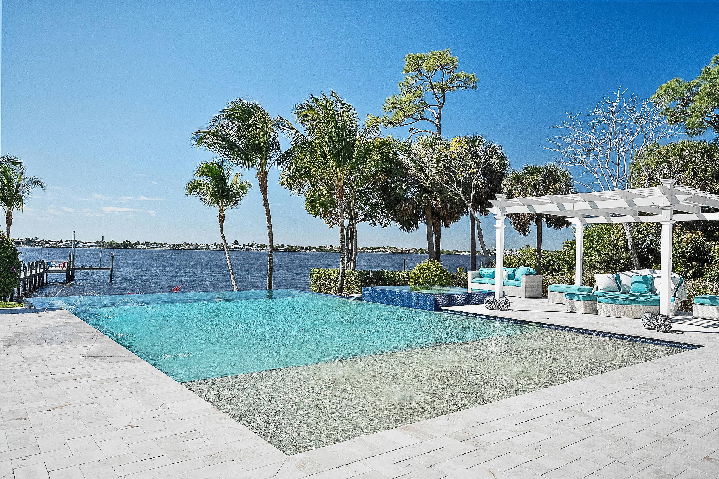Accepting all offers. Enjoy waterfront living in this 2017 custom estate, now offered at a new reduced price.