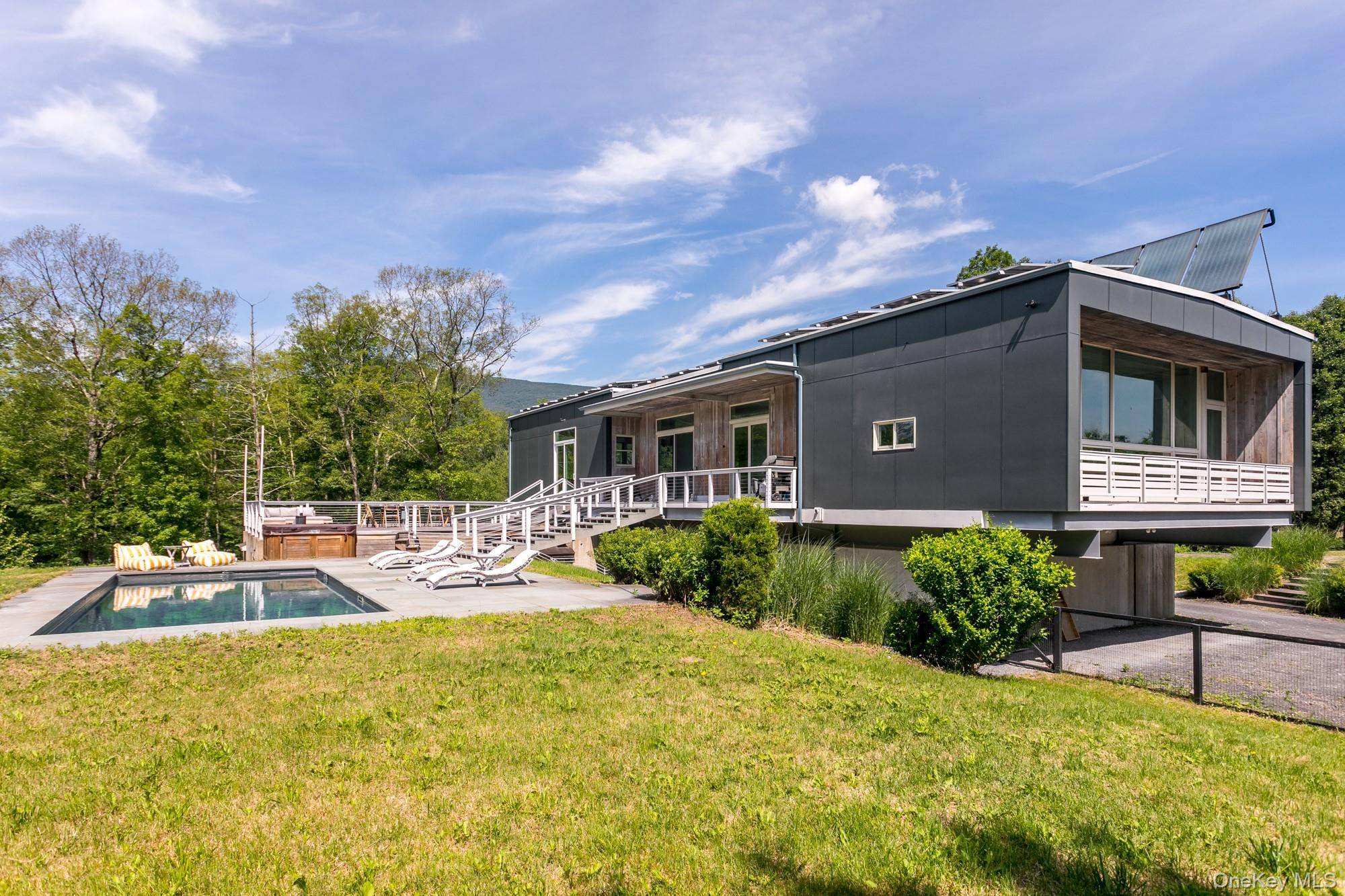 Experience unparalleled privacy and modern elegance at The Catskills Overlook, a luxurious home tucked away on a 13 acre estate surrounded by nature.