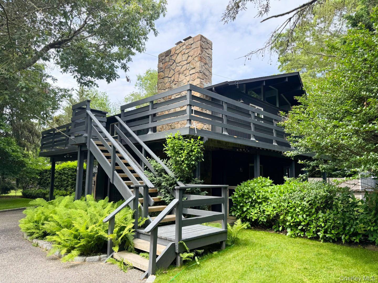 This beautiful mid century modern high ranch is located near bay beaches, restaurants, golf courses, marinas, and farm stands in Southampton North.