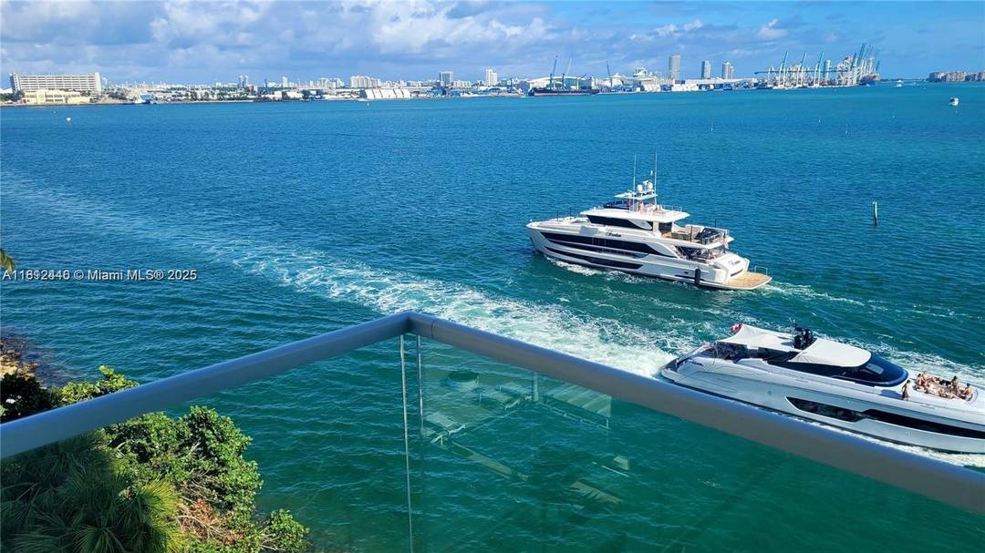 Pristine corner residence nestled in the exclusive Brickell Key Island.