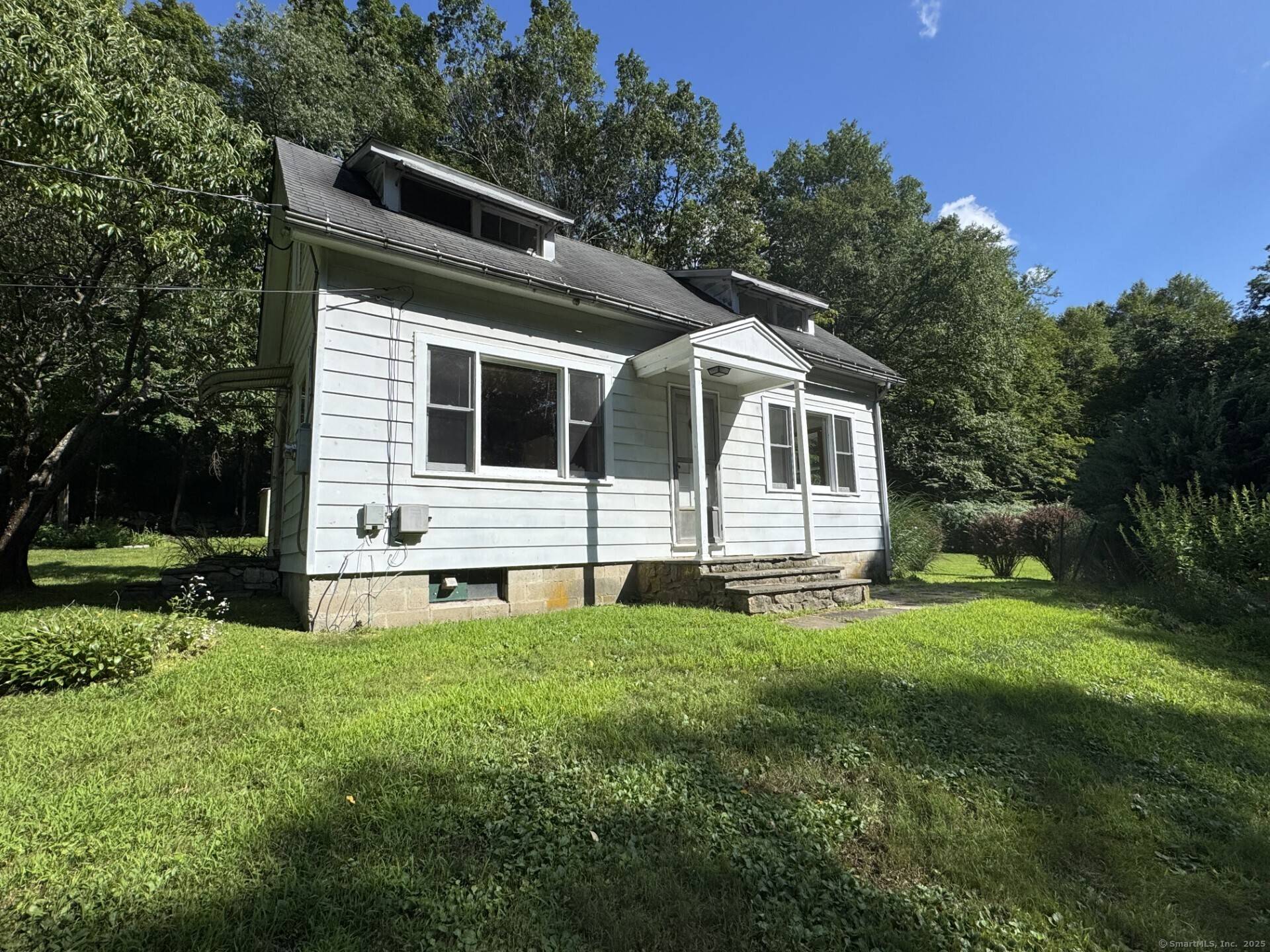 Private and charming 2 bedroom Country Cape located on 2 very pretty acres of private and landscaped property.