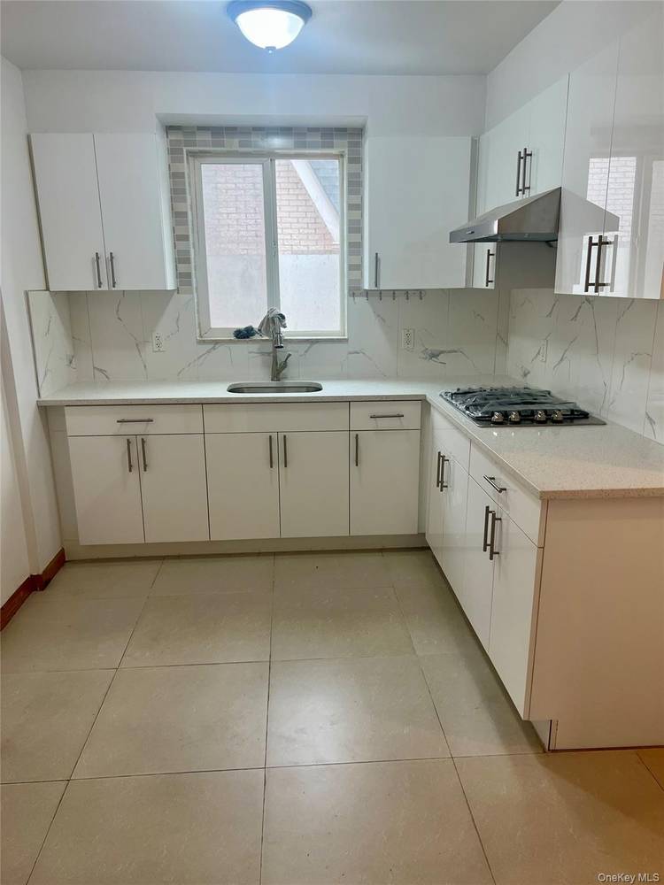 Second floor four bedroom, three bathroom apartment featuring hardwood floors throughout.