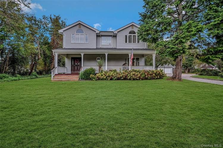 Discover the rare opportunity to live year round in the heart of South Jamesport, on one of the largest lots in the area an expansive 1.