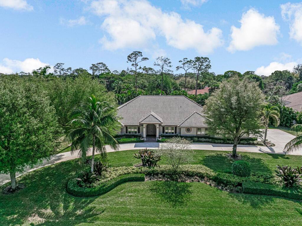 This custom built estate in sought after Pinewood spans 5, 000 sq ft on a private, lushly landscaped lot designed for both entertaining and family living.