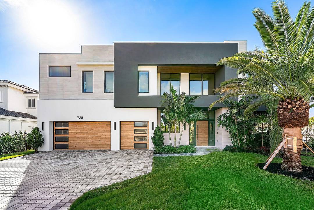 Prepare to be captivated by this extraordinary corner estate in coveted Boca Harbour, offering nearly 180 feet of deep water dockage just moments from the Intracoastal.