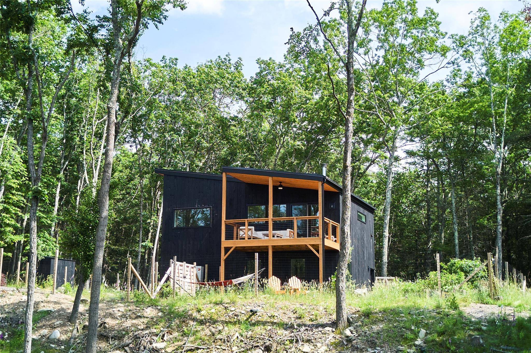 A sleek, modern escape awaits in the beautiful sanctuary of the Black Forest community in Glen Spey, NY.