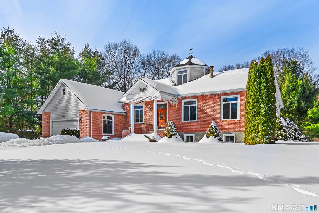 Stately and impressive home featuring a dramatic stone pillar entrance, ideally located directly across from Lake Zoar with deeded private dock access.