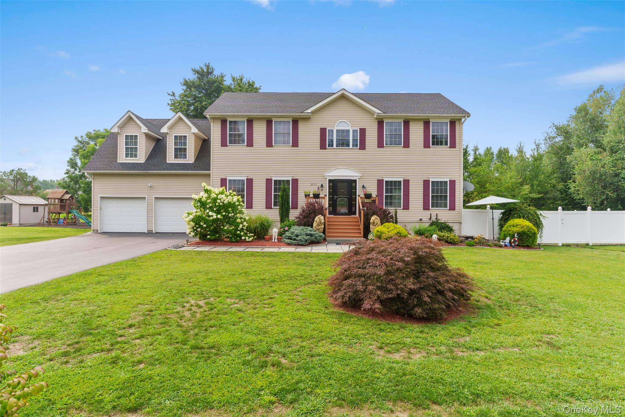 Step into timeless charm with this elegant center hall colonial.