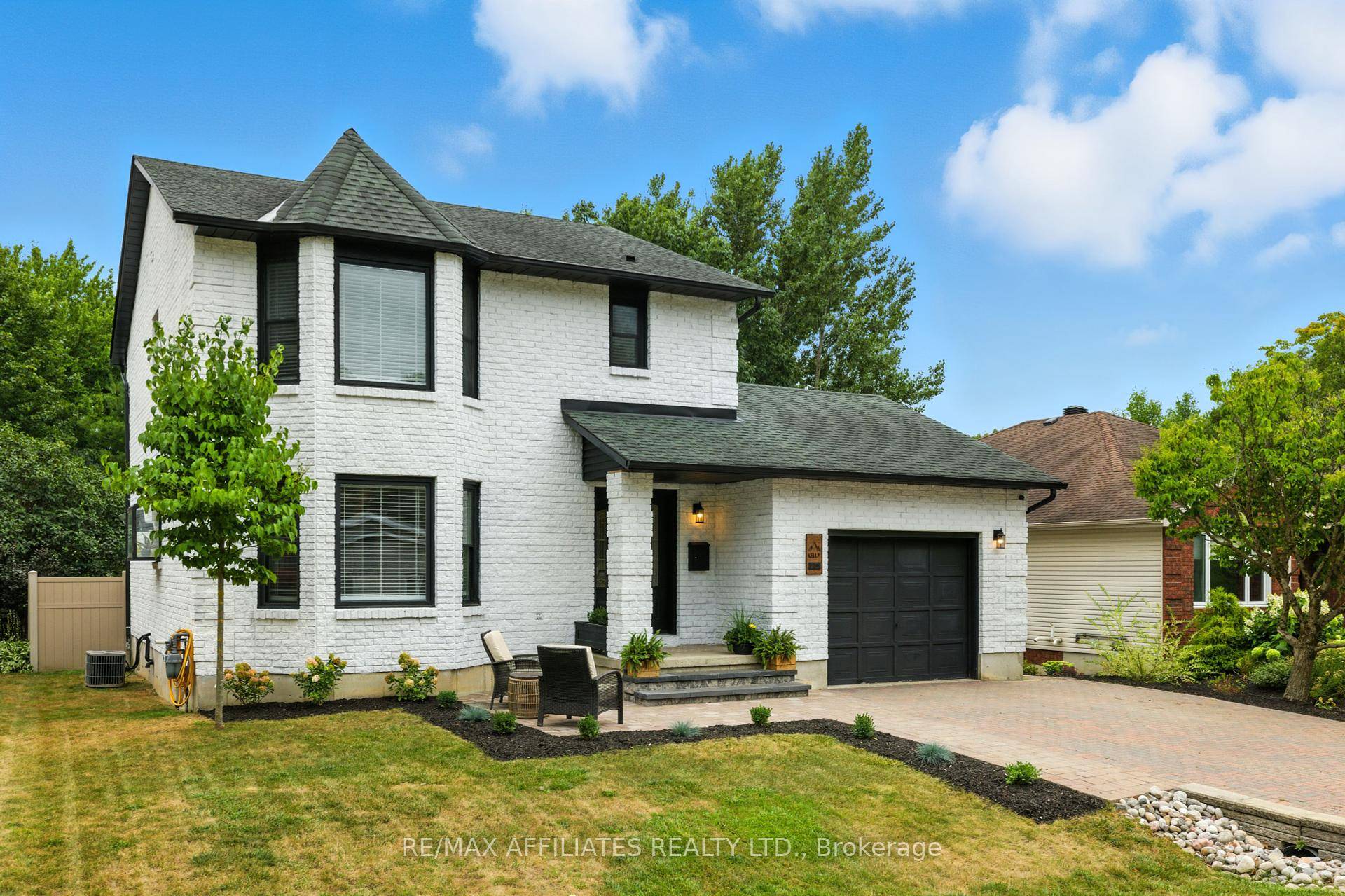 This stunning white all brick 2 storey home with timeless black accents blends contemporary upgrades with timeless charm.