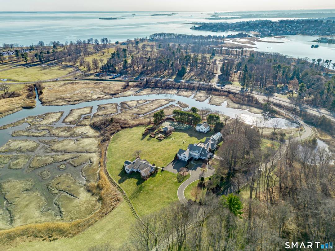 Hidden along a private lane in Westport's Greens Farms neighborhood, this extraordinary 20 acre waterfront estate unfolds as one of the most remarkable shoreline settings ever offered.