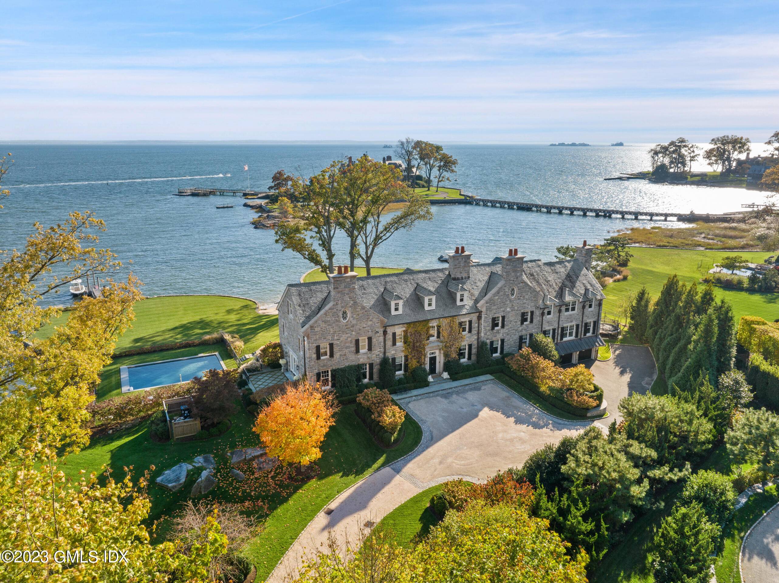 An idyllic coastal respite, this distinguished stone Georgian Colonial is direct waterfront with views of the Long Island Sound in the private Mead Point Association with 24hr guard gated security.