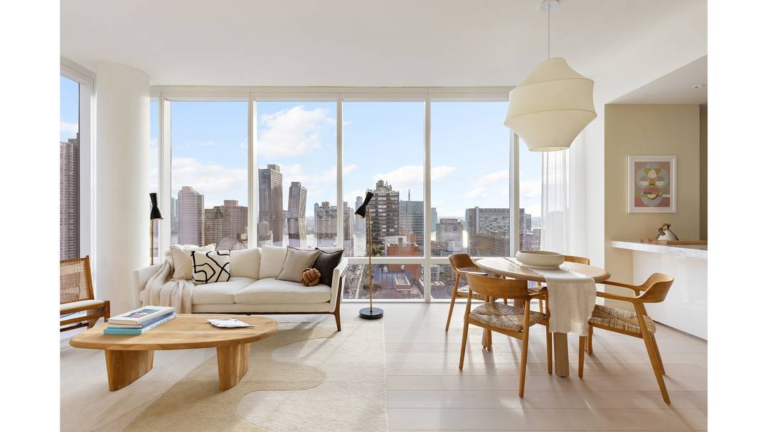 Luxury corner home with 10' floor to ceiling windows and expansive views of the River, Manhattan skyline and Long Island City.