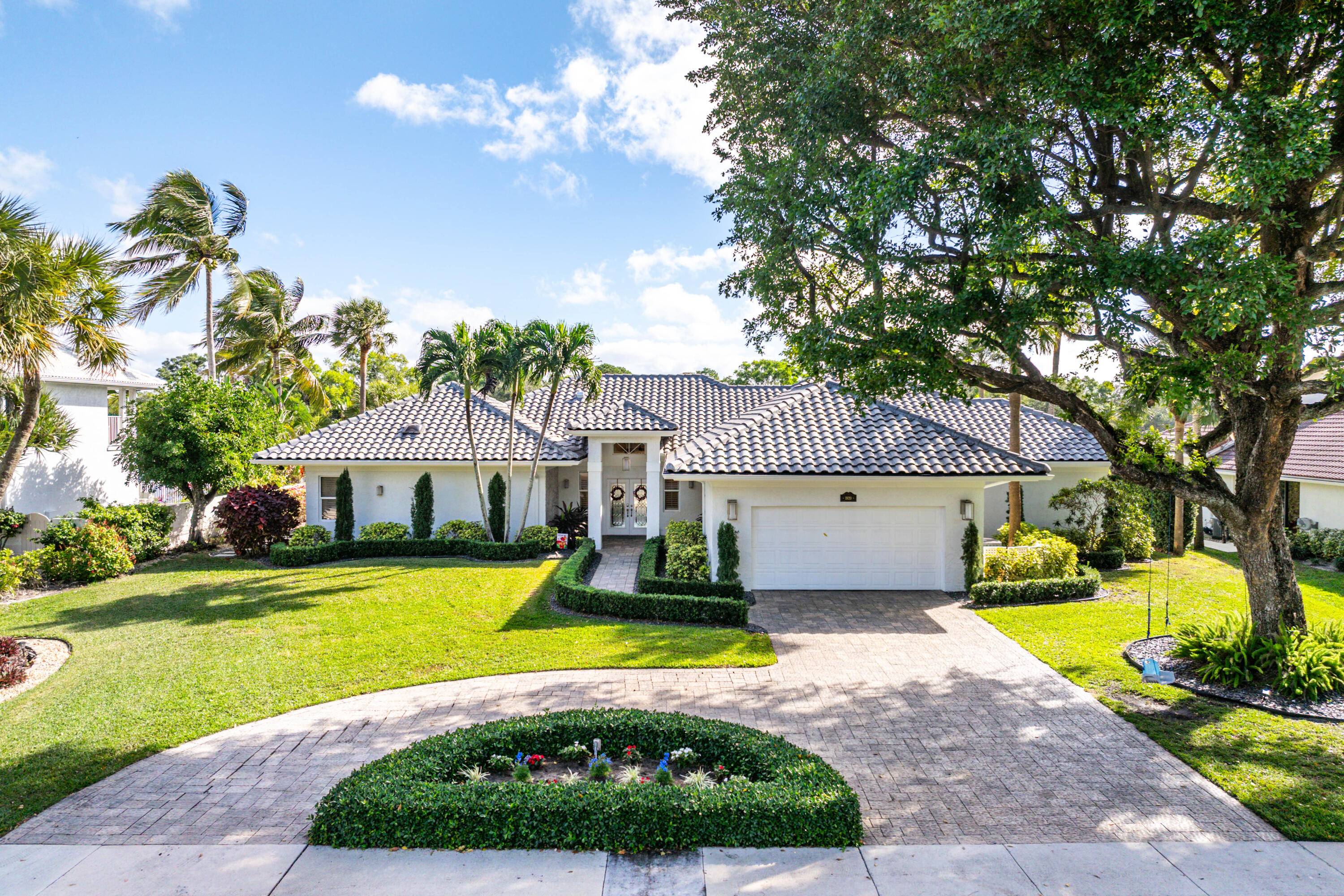 A unique opportunity to own this gorgeous estate located on a premier waterfront lot in the charming gated community of Boca Sailing Racquet Club.