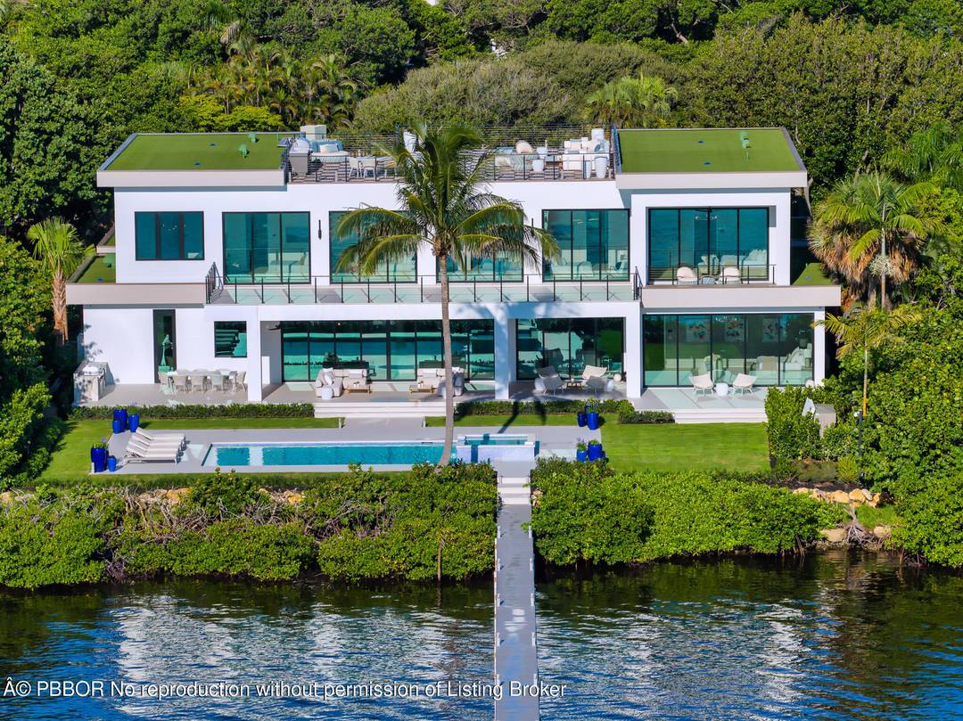 Welcome to 1422 SE Atlantic Drive, a rare opportunity to own one of the most prestigious newly completed residences on Hypoluxo Island, near Manalapan.